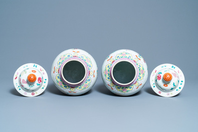 A pair of Chinese famille rose vases and covers, 19th C.