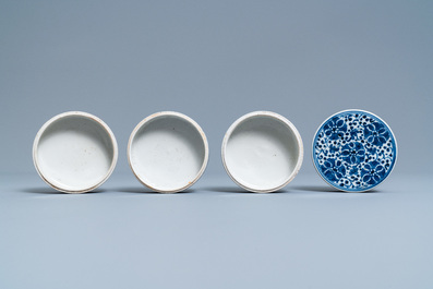 A pair of Chinese blue and white four-tier stacking boxes, a seal paste box and four saucers, 19th C.