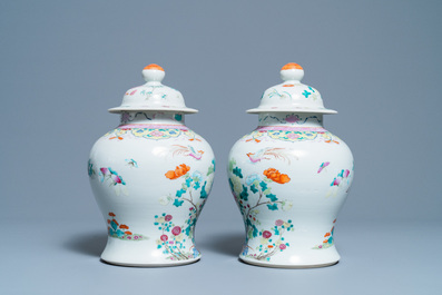 A pair of Chinese famille rose vases and covers, 19th C.