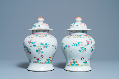 A pair of Chinese famille rose vases and covers, 19th C.
