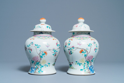 A pair of Chinese famille rose vases and covers, 19th C.