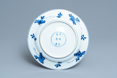 A Chinese blue and white dish with ladies around a jardini&egrave;re, Kangxi