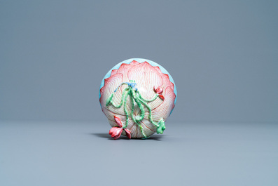 Een Chinese famille rose lotusvormige kop en schotel met reli&euml;fdecor, Yongzheng