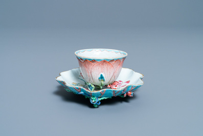 A Chinese famille rose 'lotus' cup and saucer with applied design, Yongzheng