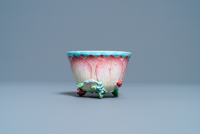 Een Chinese famille rose lotusvormige kop en schotel met reli&euml;fdecor, Yongzheng