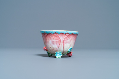 Een Chinese famille rose lotusvormige kop en schotel met reli&euml;fdecor, Yongzheng