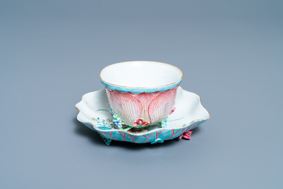 Een Chinese famille rose lotusvormige kop en schotel met reli&euml;fdecor, Yongzheng