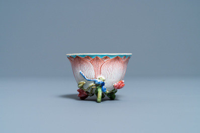 A Chinese famille rose 'lotus' cup and saucer with applied design, Yongzheng