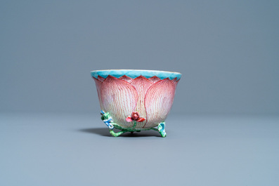 Een Chinese famille rose lotusvormige kop en schotel met reli&euml;fdecor, Yongzheng