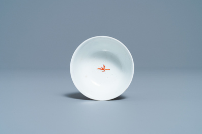 A Chinese export porcelain cup and saucer with a seamstress, Qianlong