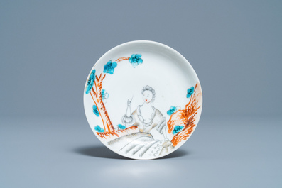 A Chinese export porcelain cup and saucer with a seamstress, Qianlong