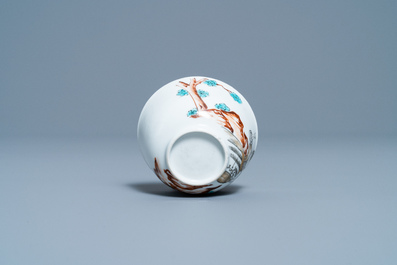A Chinese export porcelain cup and saucer with a seamstress, Qianlong