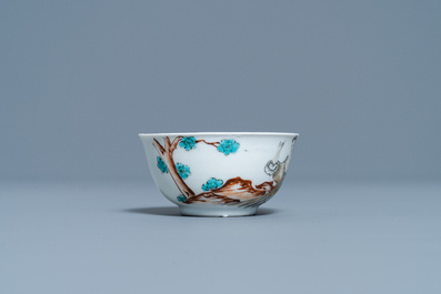 A Chinese export porcelain cup and saucer with a seamstress, Qianlong