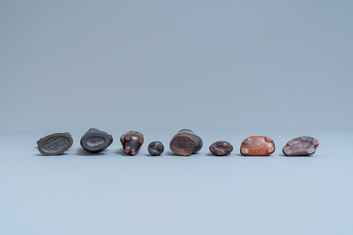 Eight Chinese scholar's rocks on wooden stands, 19/20th C.