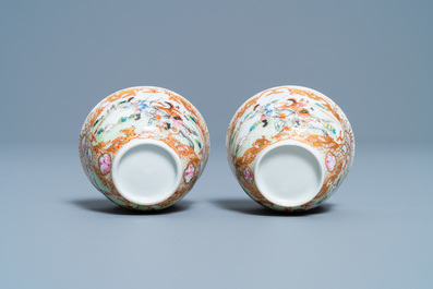 A pair of Chinese gilded famille rose 'Mongolian hunt' cups and saucers, Qianlong