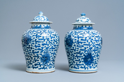 A pair of Chinese blue and white 'lotus scroll' vases and covers, Kangxi