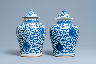 A pair of Chinese blue and white 'lotus scroll' vases and covers, Kangxi
