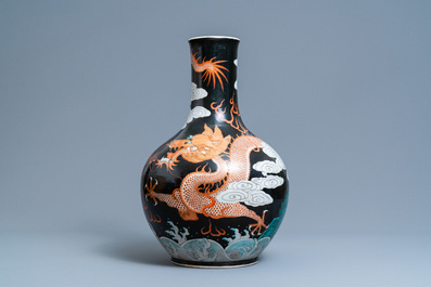 A Chinese famille noire 'dragon' bottle vase, 19th C.