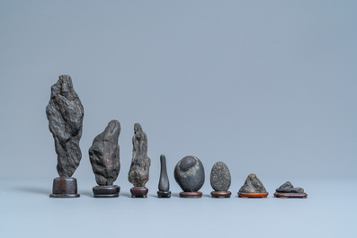 Eight Chinese scholar's rocks on wooden stands, 19/20th C.