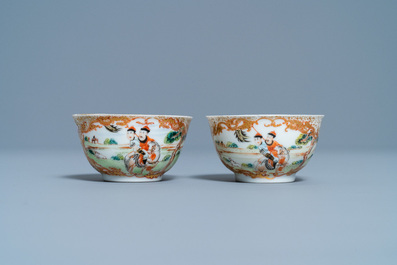 A pair of Chinese gilded famille rose 'Mongolian hunt' cups and saucers, Qianlong