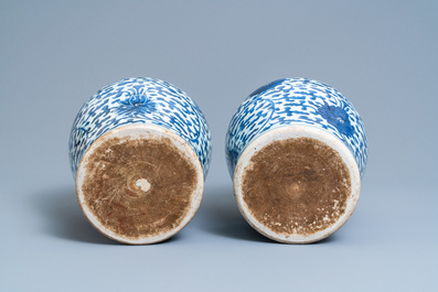A pair of Chinese blue and white 'lotus scroll' vases and covers, Kangxi