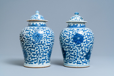 A pair of Chinese blue and white 'lotus scroll' vases and covers, Kangxi