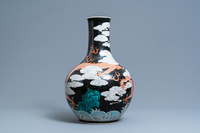 A Chinese famille noire 'dragon' bottle vase, 19th C.