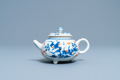 A Chinese blue, white, iron red and gilt tripod teapot and cover, Kangxi