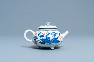 A Chinese blue, white, iron red and gilt tripod teapot and cover, Kangxi