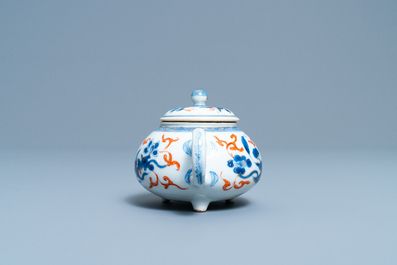 A Chinese blue, white, iron red and gilt tripod teapot and cover, Kangxi