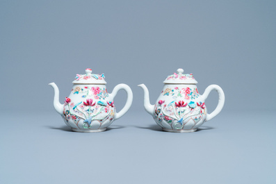 A pair of Chinese famille rose relief-decorated teapots and covers, Yongzheng