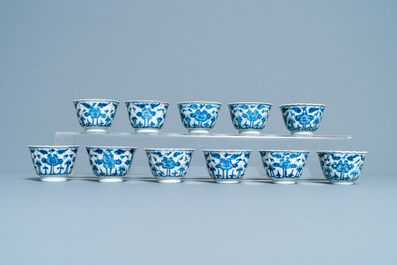 Seventeen Chinese blue and white cups and twenty-two saucers with floral design, Kangxi