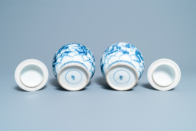 A pair of Chinese blue and white 'hunting scene' jars and covers, Kangxi