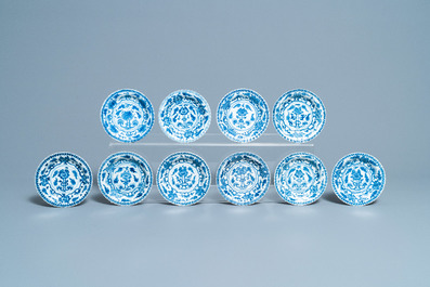 Seventeen Chinese blue and white cups and twenty-two saucers with floral design, Kangxi