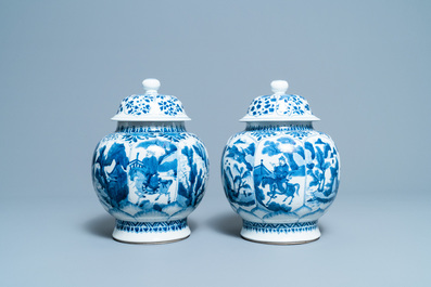 A pair of Chinese blue and white 'hunting scene' jars and covers, Kangxi
