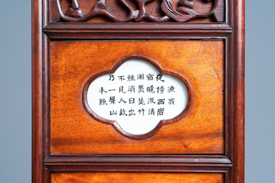 A Chinese carved wooden panel with landscape plaques, 19/20th C.