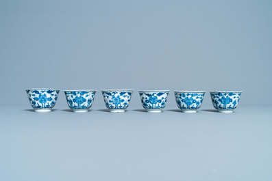 Seventeen Chinese blue and white cups and twenty-two saucers with floral design, Kangxi