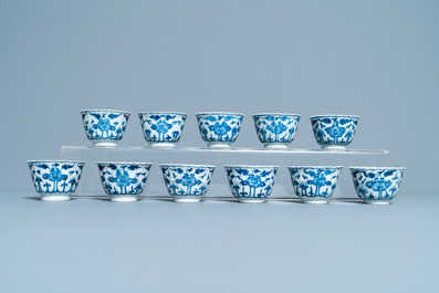 Seventeen Chinese blue and white cups and twenty-two saucers with floral design, Kangxi