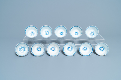 Seventeen Chinese blue and white cups and twenty-two saucers with floral design, Kangxi