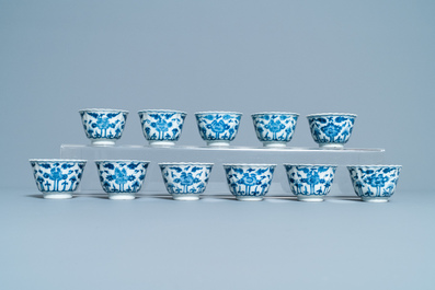 Seventeen Chinese blue and white cups and twenty-two saucers with floral design, Kangxi
