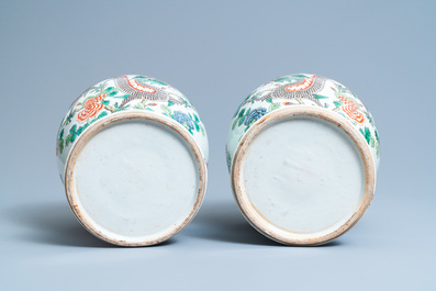 A pair of Chinese famille verte 'dragon' vases and covers, 19th C.