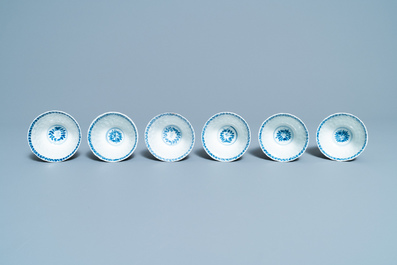 Seventeen Chinese blue and white cups and twenty-two saucers with floral design, Kangxi