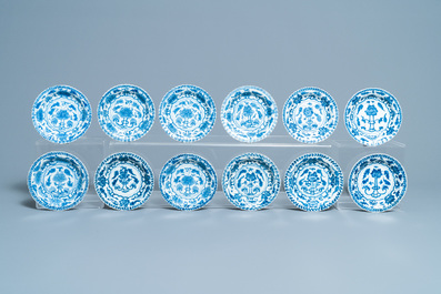 Seventeen Chinese blue and white cups and twenty-two saucers with floral design, Kangxi