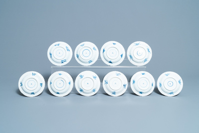 Seventeen Chinese blue and white cups and twenty-two saucers with floral design, Kangxi