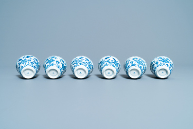 Seventeen Chinese blue and white cups and twenty-two saucers with floral design, Kangxi