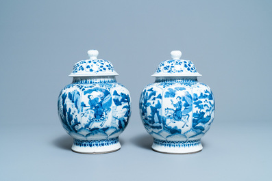 A pair of Chinese blue and white 'hunting scene' jars and covers, Kangxi