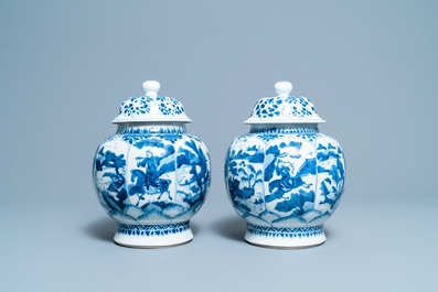 A pair of Chinese blue and white 'hunting scene' jars and covers, Kangxi