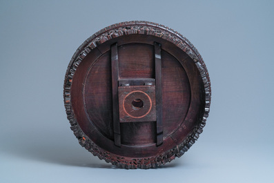 A Chinese carved wooden table with a large Canton famille verte plaque, 19th C.