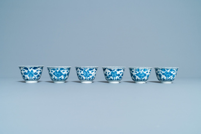 Seventeen Chinese blue and white cups and twenty-two saucers with floral design, Kangxi