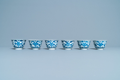Seventeen Chinese blue and white cups and twenty-two saucers with floral design, Kangxi